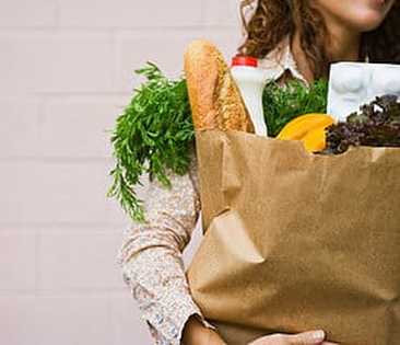 Woman holding bag of groceries 